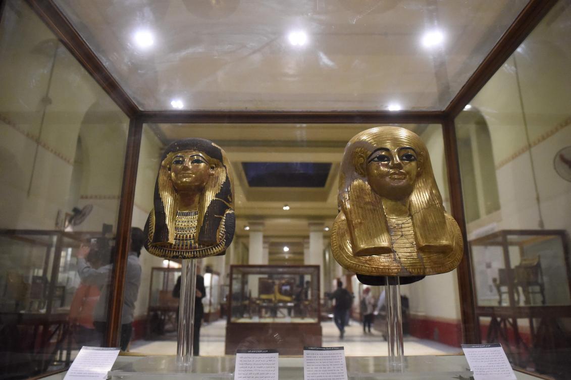 A picture taken on November 19, 2018, shows the Gilded Cartonnage Mask of Yuya (R), a powerful Egyptian courtier during the Eighteenth dynasty of Egypt, and the Gilded Cartonnage Mask of Thuya (L), an Egyptian noblewoman and the wife of Yuya, on display at the Egyptian Museum in Cairo during a ceremony celebrating the 116th anniversary of the museum. (AFP)