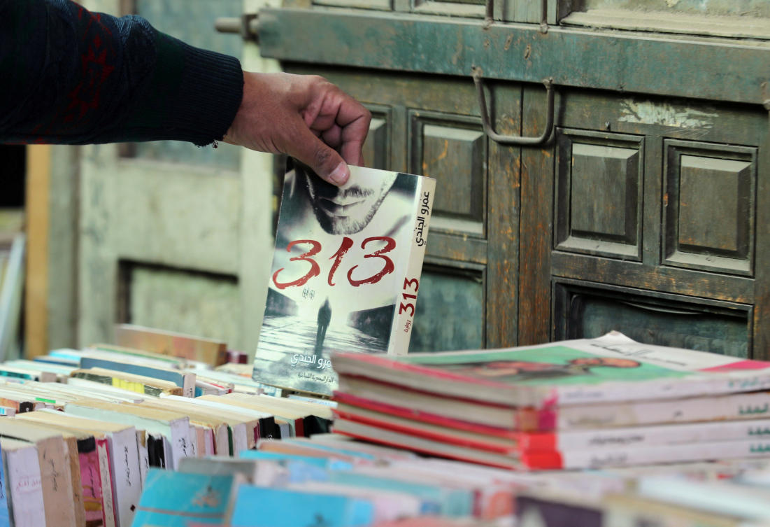 A man chooses a book at Cairo's historic Al-Azbakeya book market. (Reuters)