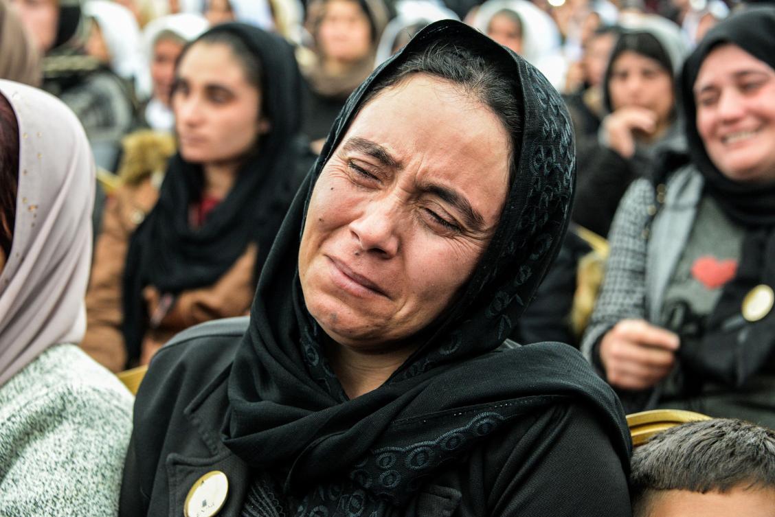 An Iraqi Yazidi woman mourns while attending the exhumation of a mass-grave of hundreds of Yazidis killed by Daesh militants in the northern Iraqi village of Kojo in Sinjar district on March 15, 2019. (AFP)
