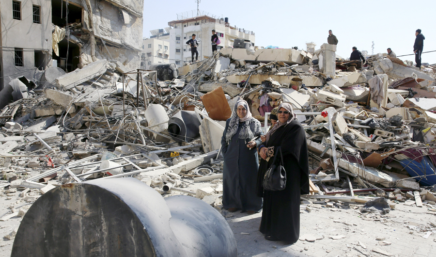 Palestinians search for their family's belongings amid the rubble of destroyed building near a Hamas security building that was destroyed in an Israeli airstrike late Monday, in Gaza City, Wednesday, on March 27, 2019. (AP)