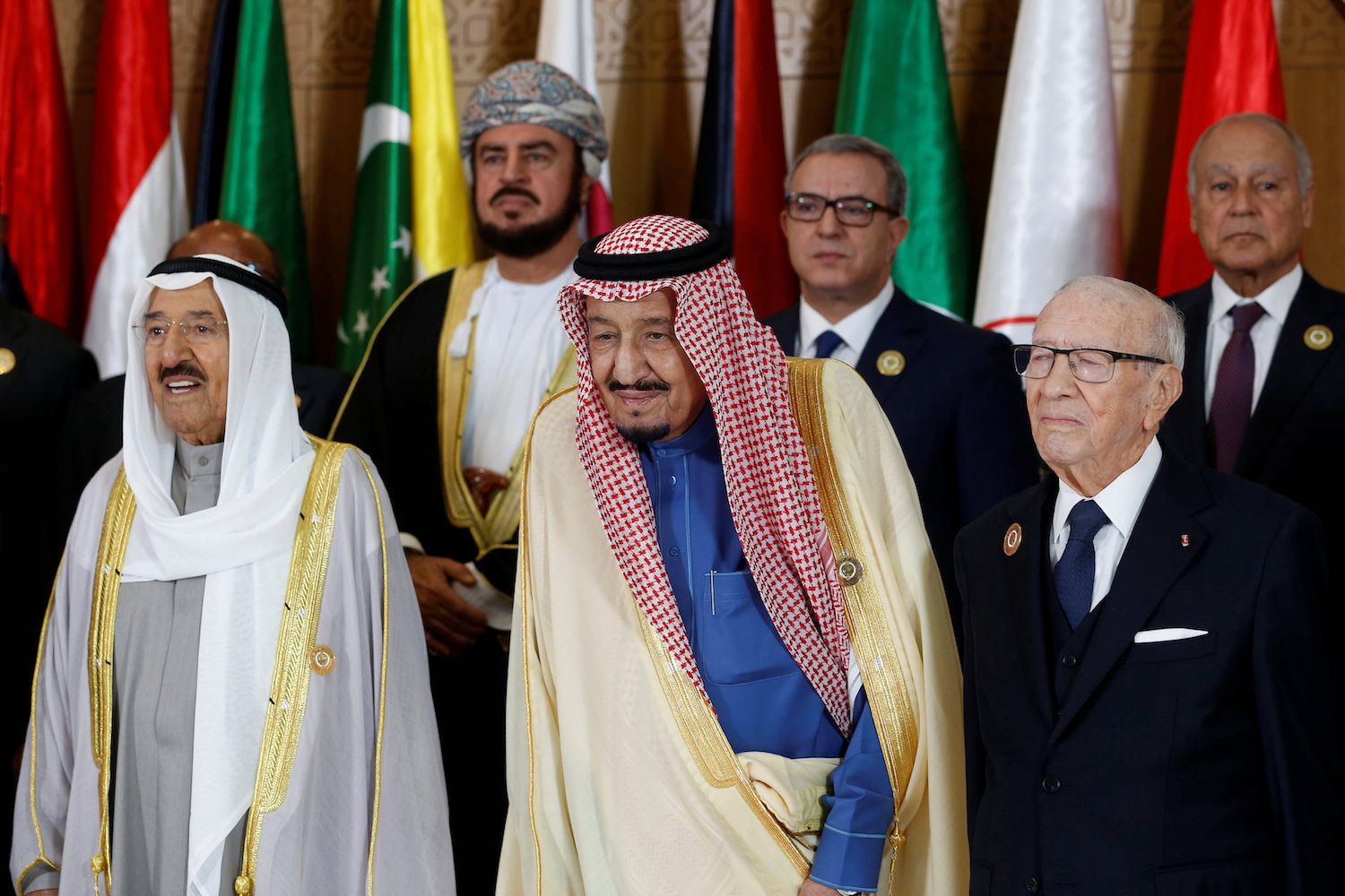 (L to R) Kuwaiti Emir Sheikh Sabah Al-Ahmad Al-Jaber Al-Sabah, Saudi Arabia's King Salman bin Abdulaziz, and Tunisian President Beji Caid Essebsi stand together for the group family photo with other Arab leaders during the 30th Arab League summit in the Tunisian capital Tunis on March 31, 2019. (AFP)