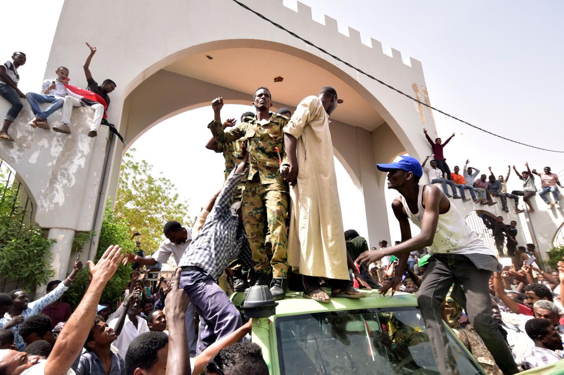 Sudanese demonstrators gather in a street in central Khartoum on April 11, 2019, after one of Africa's longest-serving presidents was toppled by the army. (AFP)