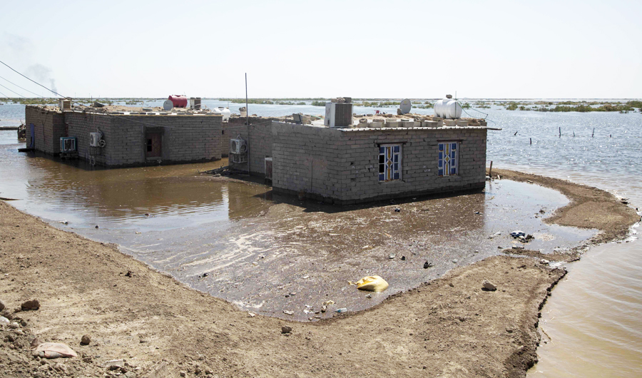 Flooded houses are pictured in southern Iraq's al-Qurna district, north of Basra. (AFP)