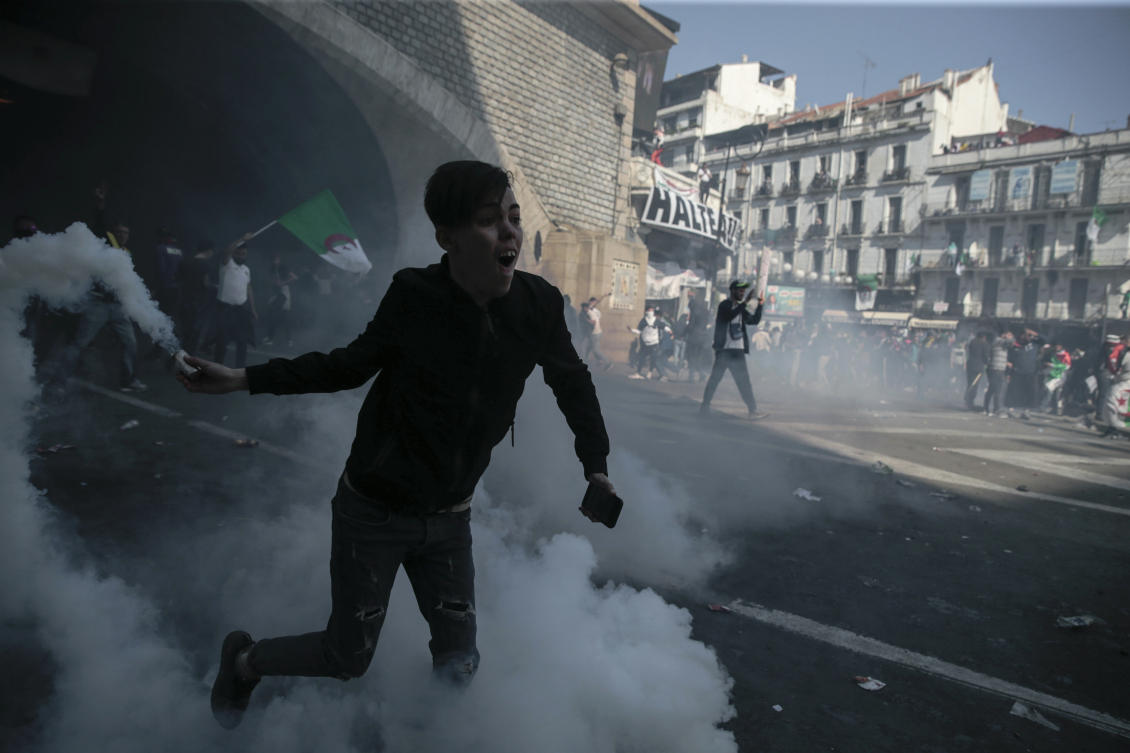 Protesters clash with police officers during a demonstration against the country's leadership, in Algiers, Friday, April 12, 2019. (AP)