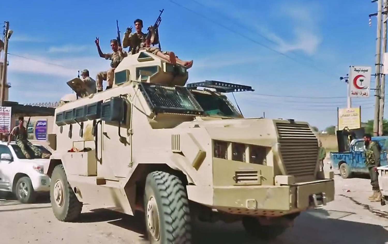 This grab obtained from a video shows Libyan National Army fighters riding atop an armoured vehicle waving gestures and chanting slogans while driving reportedly in a southern suburb of the capital Tripoli. (AFP)