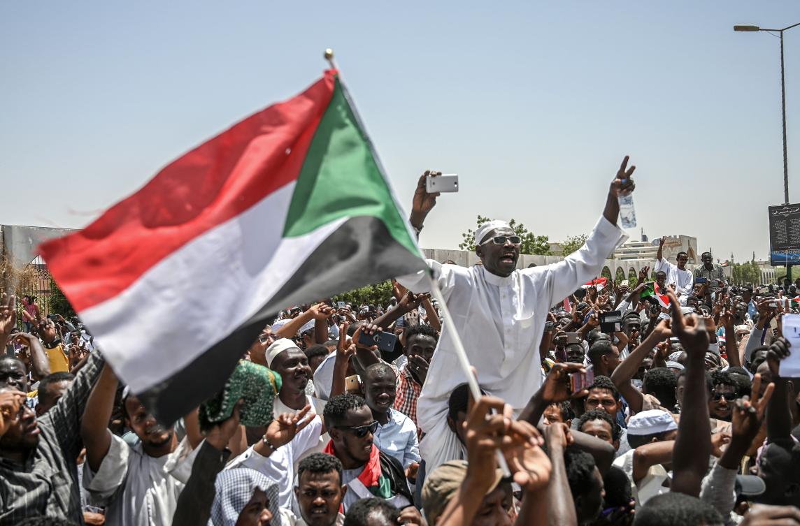 Sudanese protesters wave a national flag and chant slogans during an a sit-in outside the army headquarters in the capital Khartoum on Friday. (AFP)