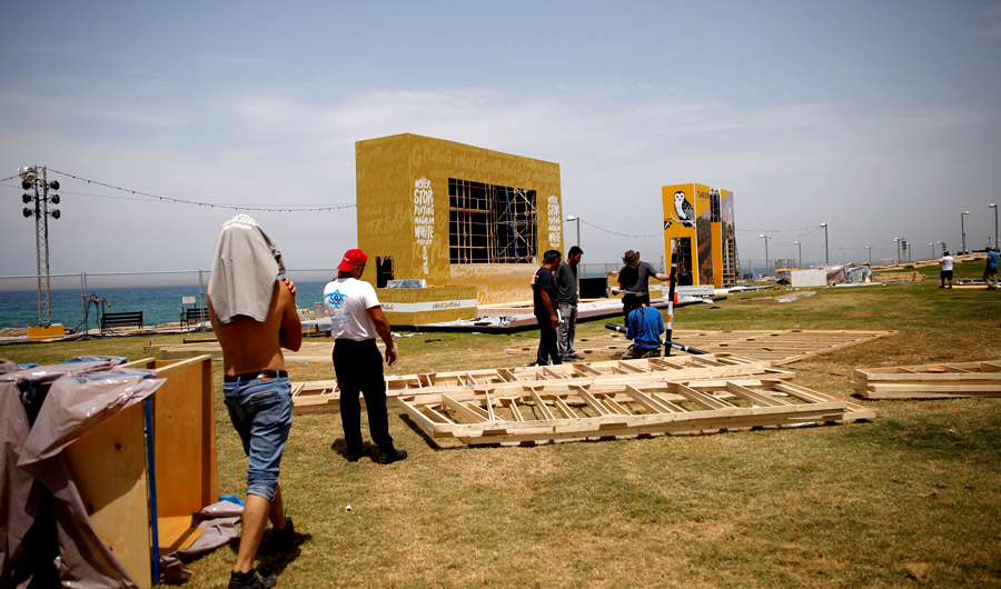 Laborers work on the construction of stands that will be located besides the Eurovision Village, a space dedicated for fans of the upcoming Eurovision Song Contest, in Tel Aviv, Israel May 6, 2019. (Reuters)