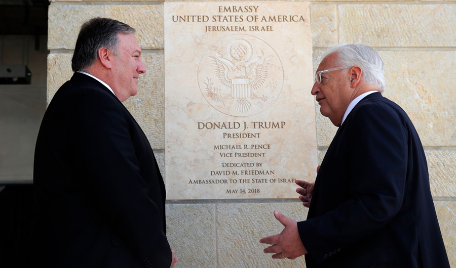 In this file photo taken on March 21, 2019, US Secretary of State Mike Pompeo and US ambassador to Israel David Friedman stand next to the dedication plaque at the US embassy in Jerusalem. (AFP / POOL / JIM YOUNG)