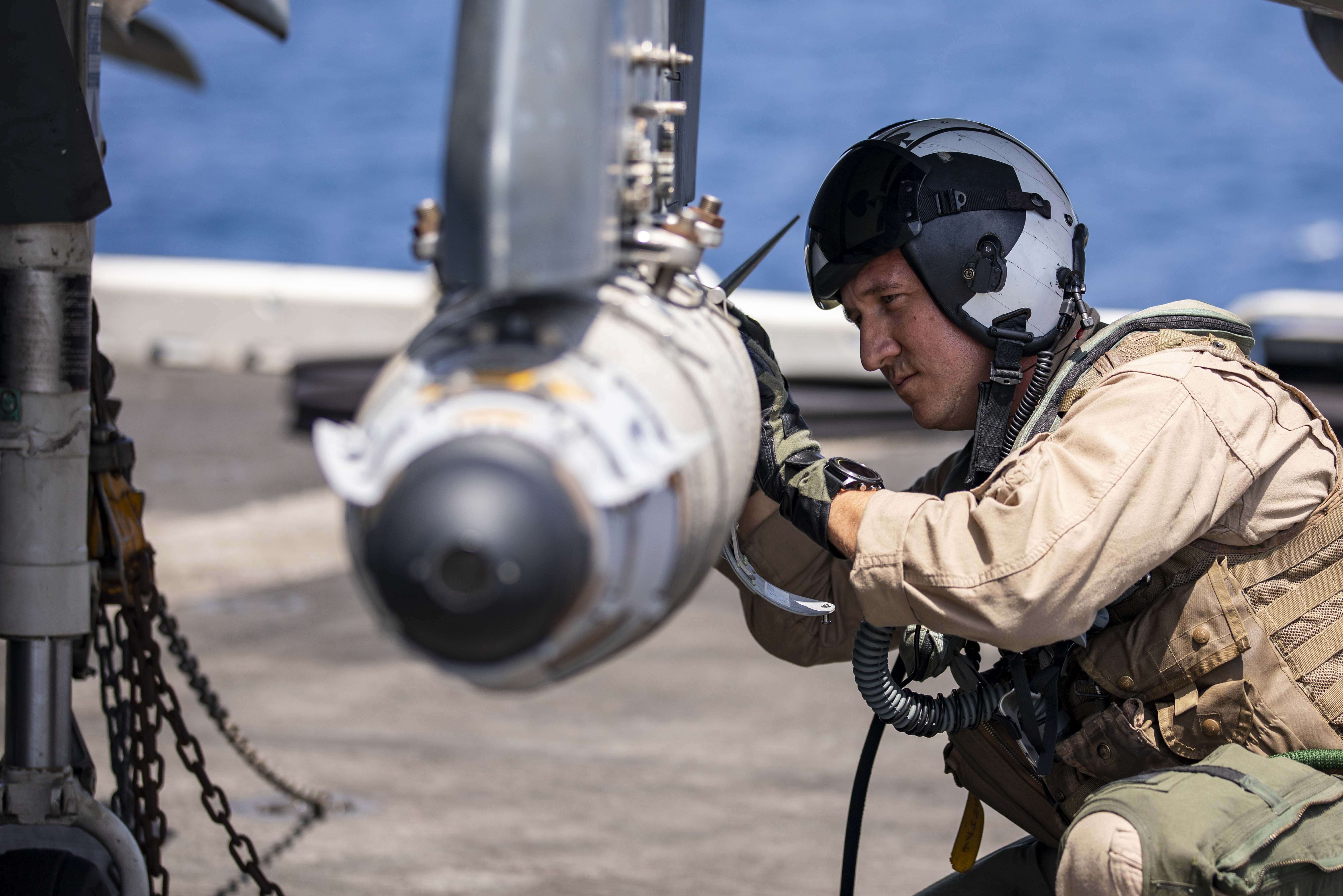 A Harrier pilot carries out pre-flight checks on the flight deck of the USS Kearsarge in the Arabian Sea this week. (US Navy)