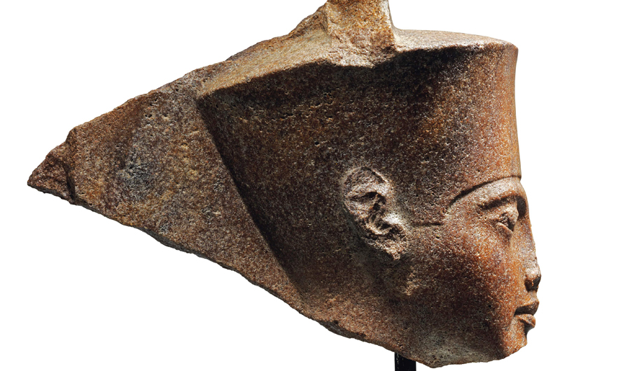 A handout picture released by Christies auction house in London on June 11, 2019 shows an ancient sculpture representing King Tutankhamun's head. The Egyptian embassy in London requested that Britain prevent the planned sale by Christie's of an ancient sculpture representing King Tutankhamun's head and return it to Egypt, Cairo said. (AFP)