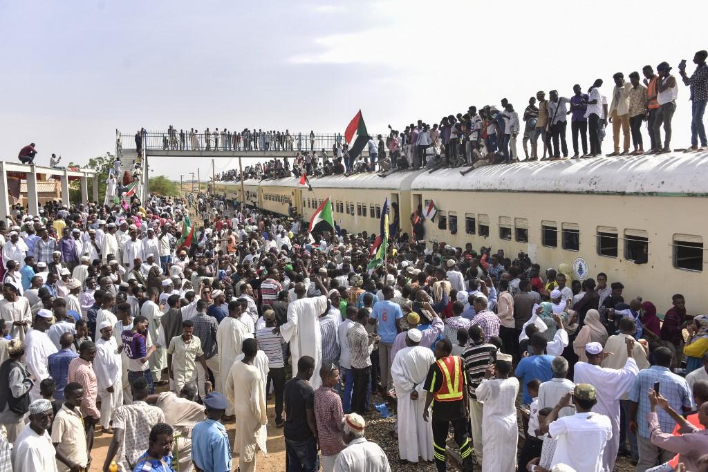 Protesters from the city of Atbara arrive at the Bahari station in Khartoum on August 17, 2019, to celebrate transition to civilian rule. (AFP)