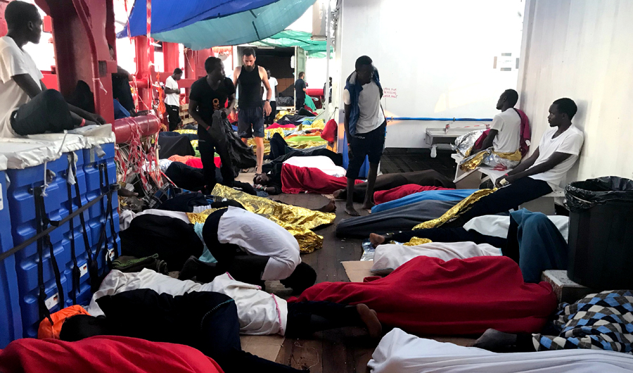 Rescued migrants sleep on deck of the 'Ocean Viking' rescue ship, jointly operated by French NGOs SOS Mediterranee and Medecins sans Frontieres (MSF) on August 17, 2019, during a search-and-rescue operation in the Mediterranean Sea. (AFP)