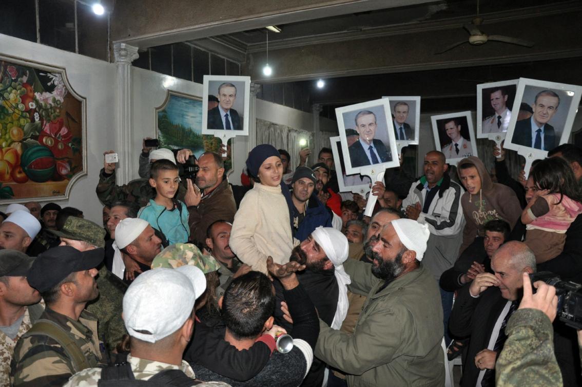 A group of Druze women and children, abducted in July from Sweida by the Daesh group, being welcomed by relatives upon their arrival overnight in their hometown in the southern Syrian province of Sweida. (File/AFP)