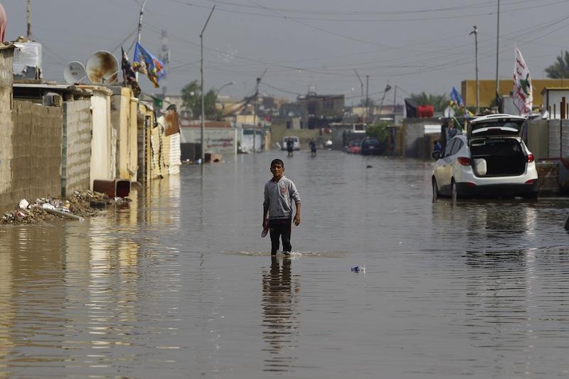 A boy stands at a flooded street after heavy rainfall in Baghdad in this file picture taken on October 31 2015. (Reuters)