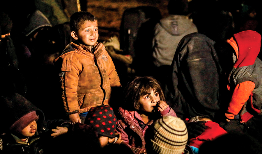 Women and children evacuated from Daesh's holdout of Baghouz wait in a zone held by the Syrian Democratic Forces. (AFP)