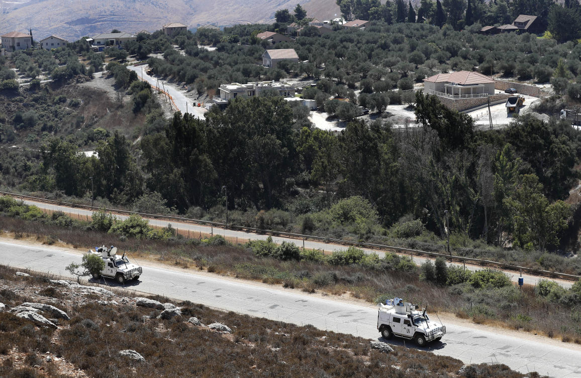 UN peacekeepers patrol along the Lebanese-Israeli border, with the Israeli village of Metulla, background, in the village of Kfar Kila, Lebanon, Monday. (AP)
