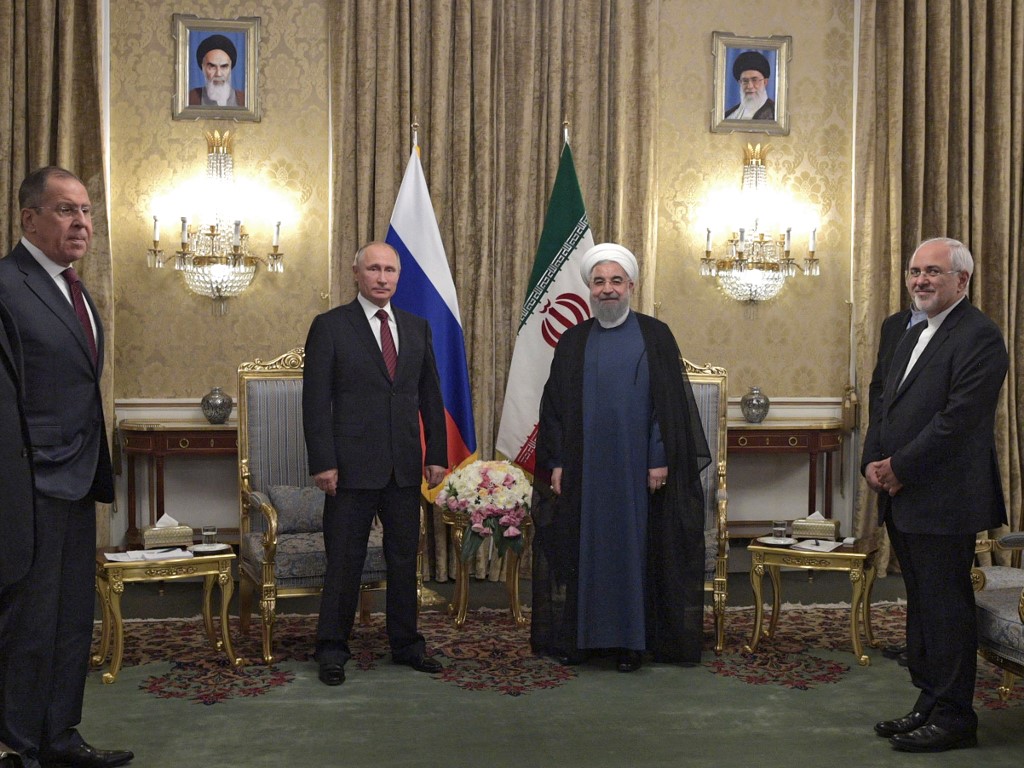 Russian President Vladimir Putin (2nd L), accompanied by Foreign Minister Sergei Lavrov (L), and Iranian President Hassan Rouhani (2nd R), accompanied by Foreign Minister Mohammad Javad Zarif (R) pose during a meeting in Tehran. (File/AFP)