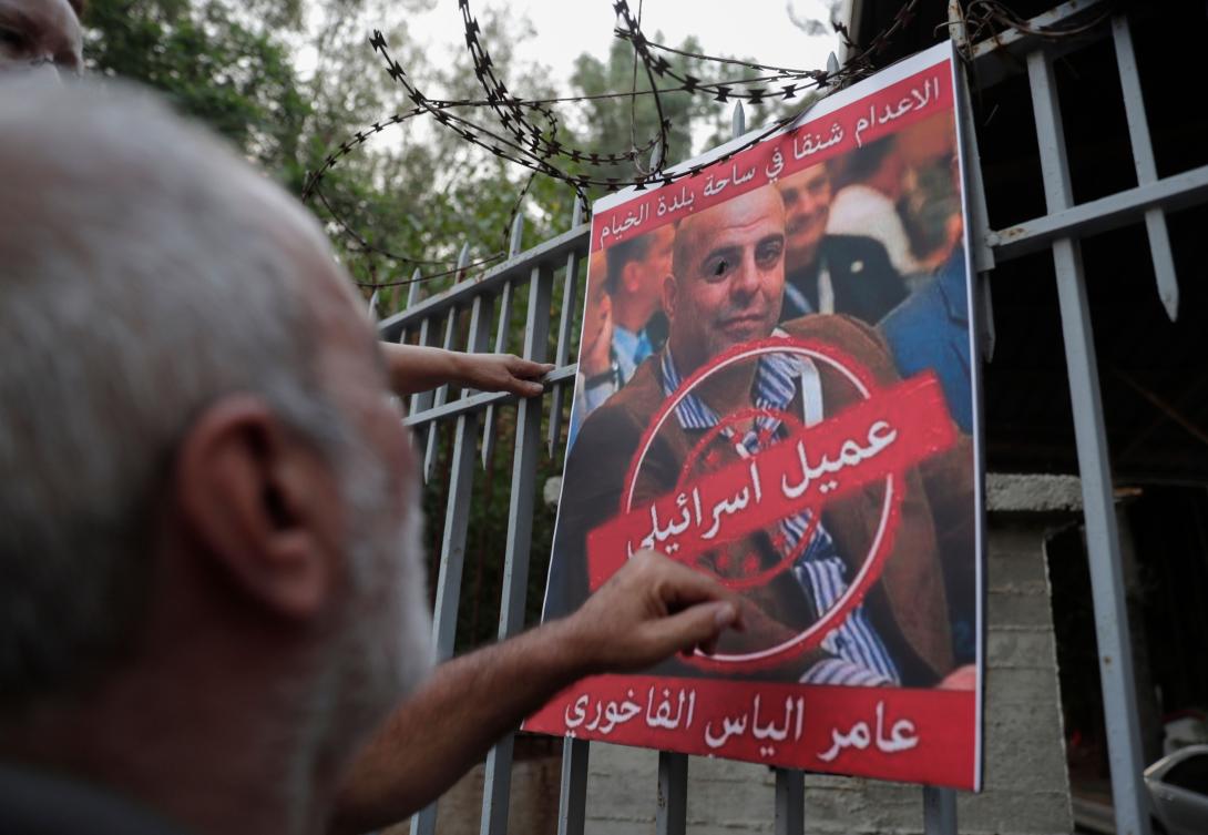 A man formerly detained by the pro-Israel South Lebanon Army (SLA) militia reacts towards a poster depicting former SLA member Amer Fakhoury, during a demonstration denouncing his return and entry outside the Justice Palace in the Lebanese capital Beirut on September 12, 2019. (AFP)