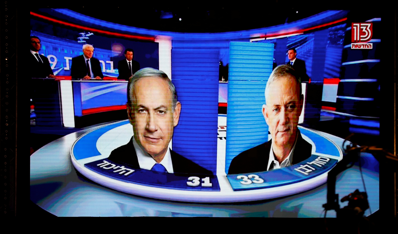 The results of the exit polls are shown on a screen at Benny Gantz's Blue and White party headquarters, following Israel's parliamentary election, in Tel Aviv. (Reuters)