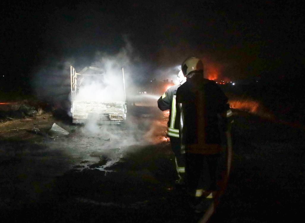 Firefighters extinguish the flames of a burning truck at the spot where Abu Hassan al-Muhajir, Daesh's spokesman was reportedly killed in a raid in the northern Syrian village of Ain Al-Bayda near Jarablus on Sunday. (AFP)