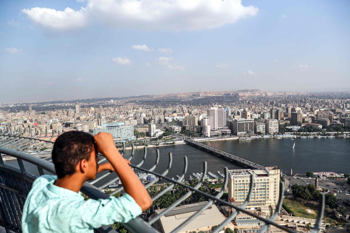 A boy looks from the observation deck of the Cairo Tower in the centre of the Egyptian capital on October 23, 2019, at a view of the Nile river flowing through the city between the central downtown (background) and Zamalek districts (foreground). (AFP)
