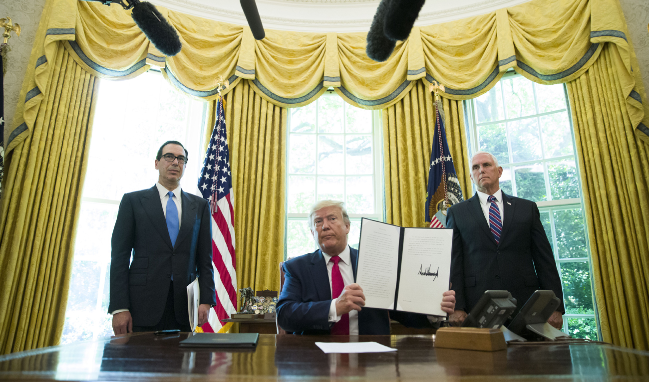 US President Donald Trump holds up a signed executive order to increase sanctions on Iran. (File/AP)