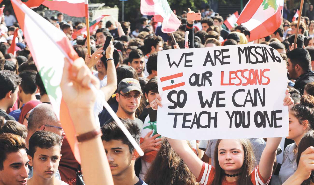 Lebanese students rally in front of the Ministry of Education during ongoing anti-government protests, in the capital Beirut on Thursday. (AFP)