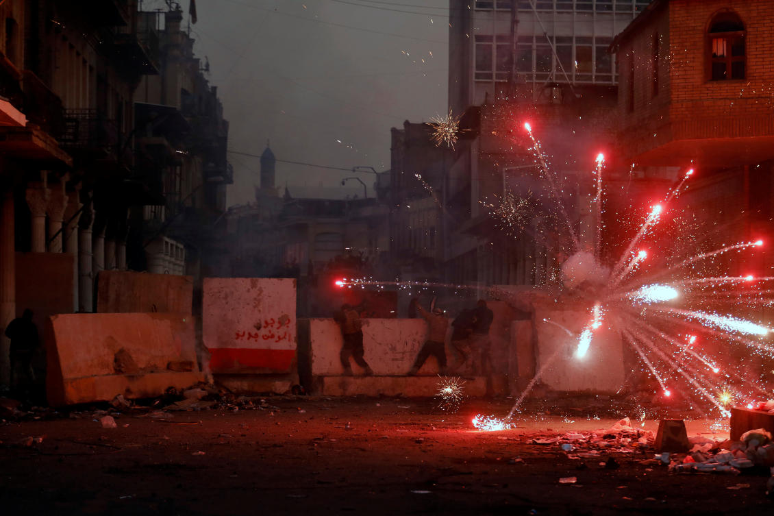 Iraqi demonstrators throw fireworks towards Iraqi security forces during the ongoing anti-government protests in Baghdad, Iraq November 26, 2019. (Reuters)