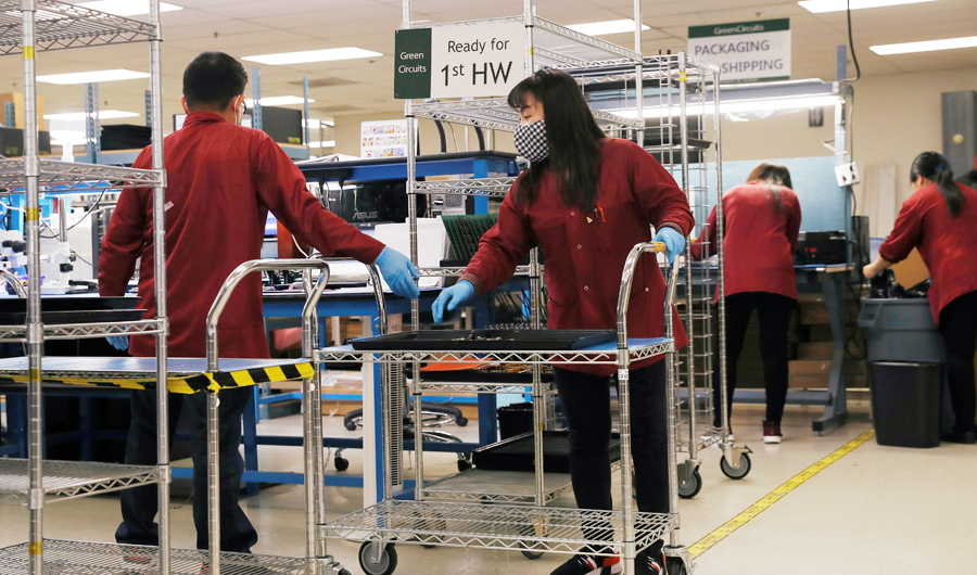 A masked worker moves a cart at Green Circuits as the company, an essential business, adapts to operating during the outbreak of the fast-spreading coronavirus disease (COVID-19) in San Jose, California, U.S., April 2, 2020. (REUTERS)