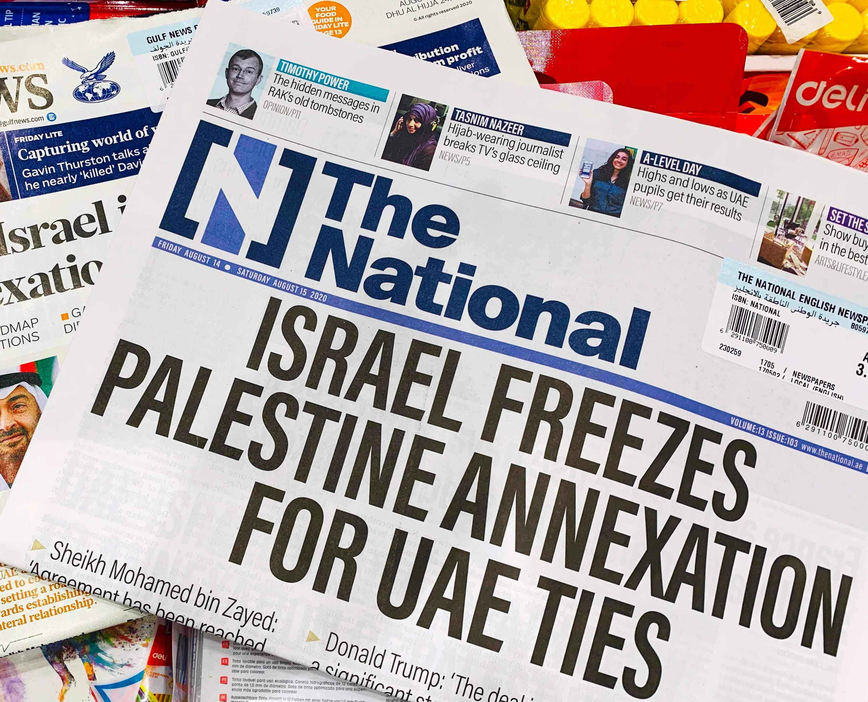 Headlines of the UAE-based newspapers reflect the agreement between the UAE and Israel to normalize relations, in Dubai on Friday. (AFP)