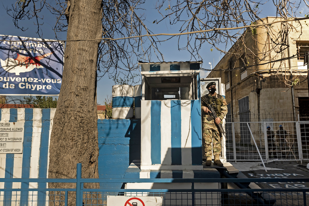 A Cypriot National Guard soldier wearing a face mask stands guard at a security outpost near the buffer zone in Nicosia, the world's last divided capital, on November 26, 2020. (AFP/File Photo)