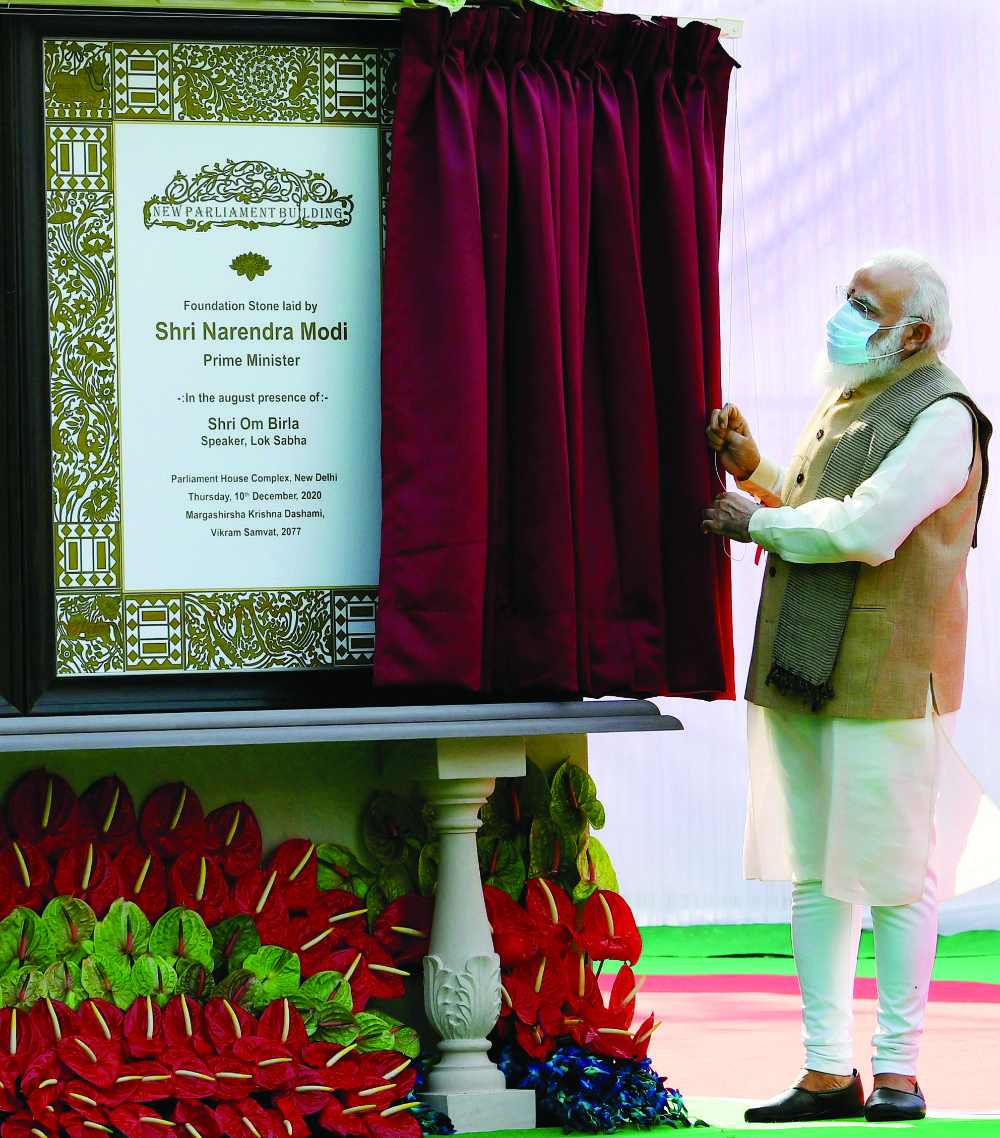 India’s Prime Minister Narendra Modi unveiling the plaque to lay the foundation stone of the new parliament building. (AFP)