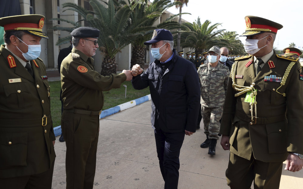 Turkey's Defense Minister Hulusi Akar, center, greet Libyan commanders in Tripoli, Libya, on Dec, 26, 2020 on his arrival to meet with allies in Libya's Government of National Accord.(Turkish Defense Ministry via AP, Pool)