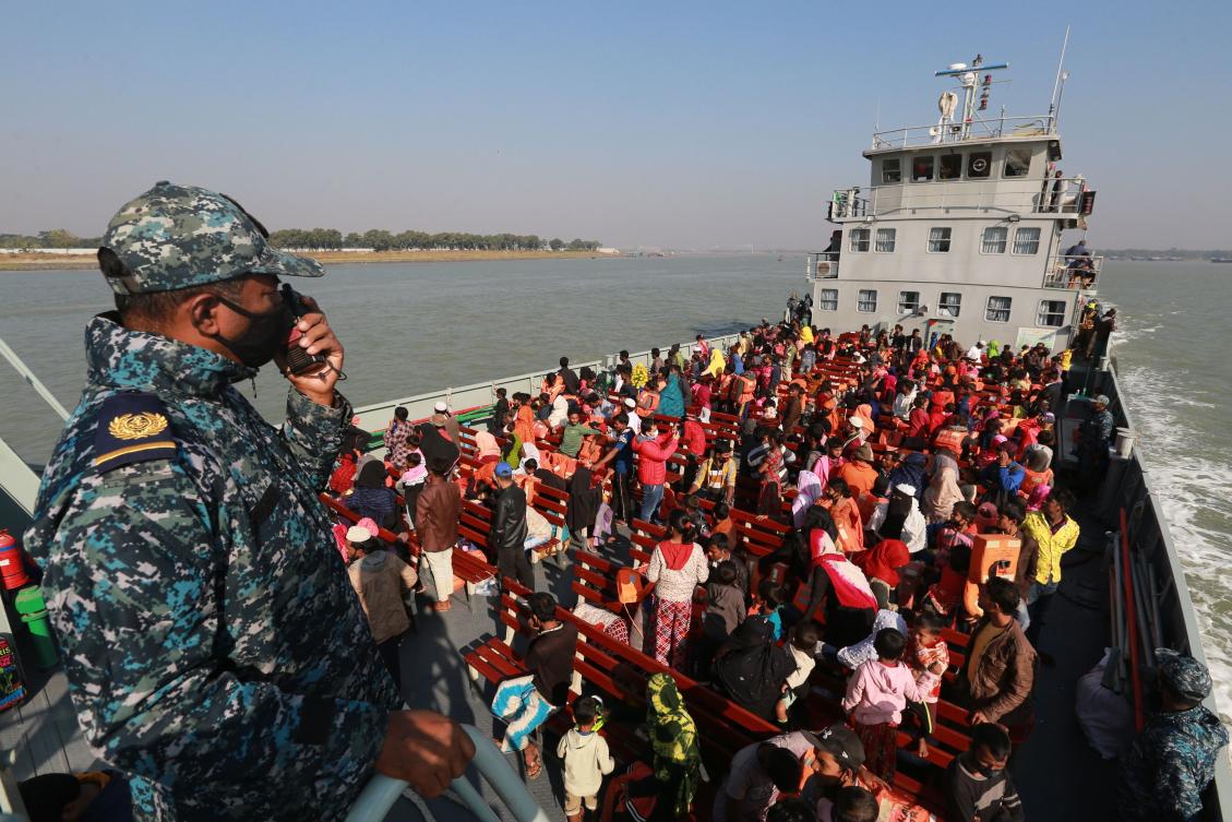 Rohingya refugees sit on a Bangladesh Navy ship as they are relocated to the controversial flood-prone island Bhashan Char in the Bay of Bengal, in Chittagong on December 29, 2020. (AFP)