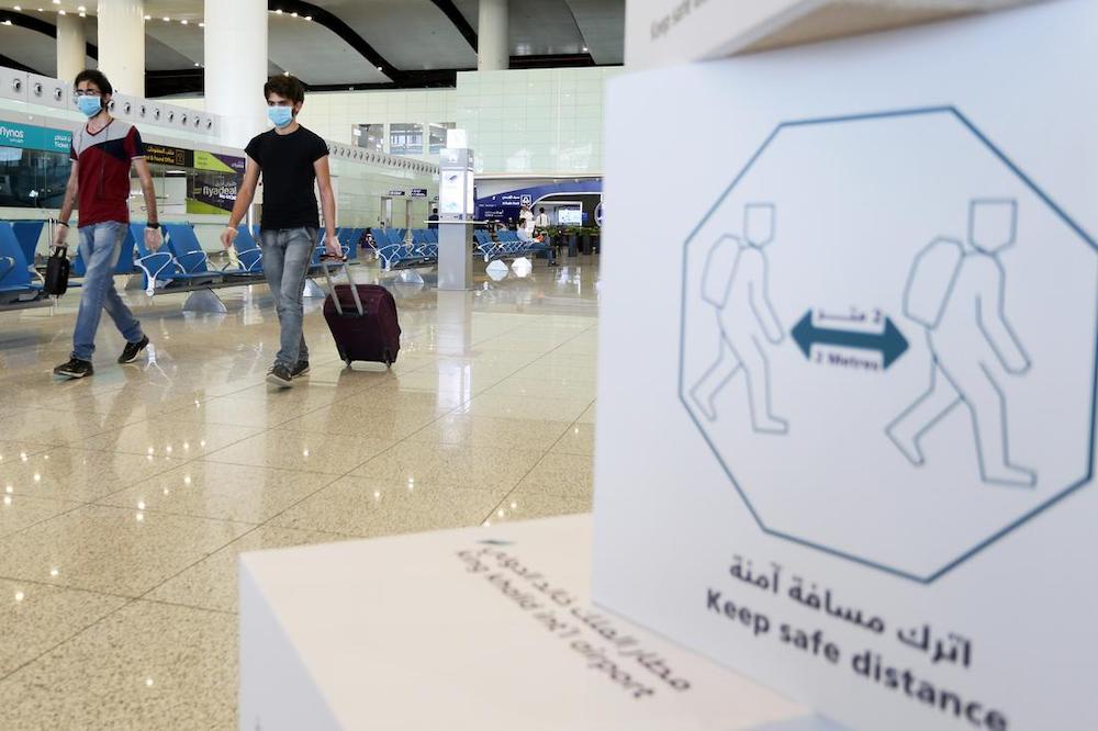 Travelers wearing protective face masks walk at Riyadh International Airport, after Saudi Arabia reopened domestic flights in Riyadh, Saudi Arabia. (File/Reuters)