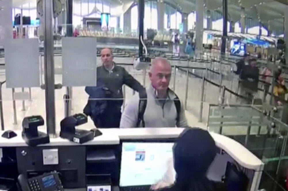This Dec. 30, 2019 image from security camera video shows Michael L. Taylor, center, and George-Antoine Zayek at passport control at Istanbul Airport in Turkey.  (DHA via AP)