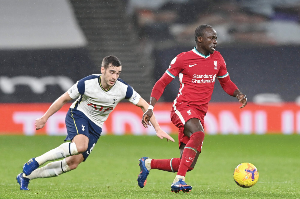 Liverpool’s Senegalese striker Sadio Mane, right, and Tottenham Hotspur’s English midfielder Harry Winks in action at Thursday’s match in London. (AFP)