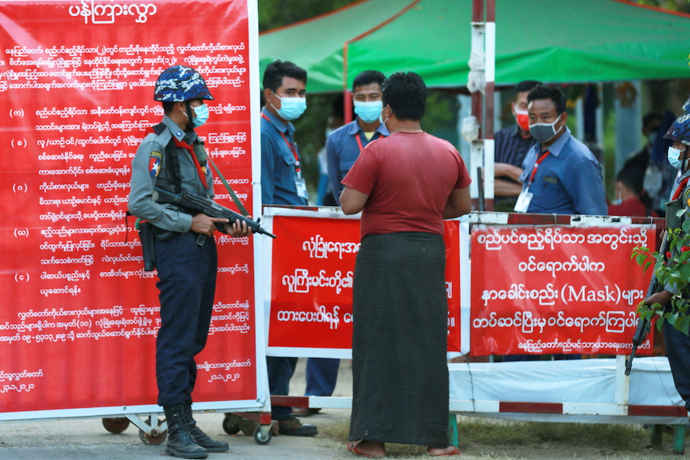 Myanmar’s police officers stand guard at the entrance of parliament members residence at the congress compound in Naypyitaw, Myanmar, Feb. 2, 2021. (Reuters)