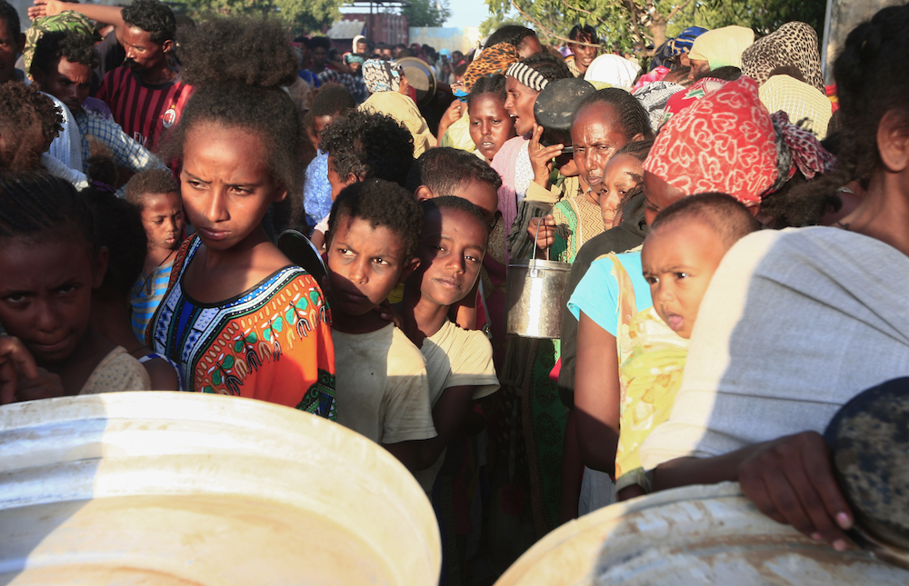 Ethiopian refugees who fled intense fighting in their homeland of Tigray, wait for their ration of food in the border reception centre of Hamdiyet, in the eastern Sudanese state of Kasala, on November 14, 2020. (AFP/File Photo)