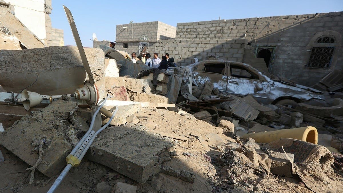 People stand near the site of a ballistic missile attack by the Iran-backed Houthi in the populated Rawda district in Marib, Yemen. (File/Reuters)