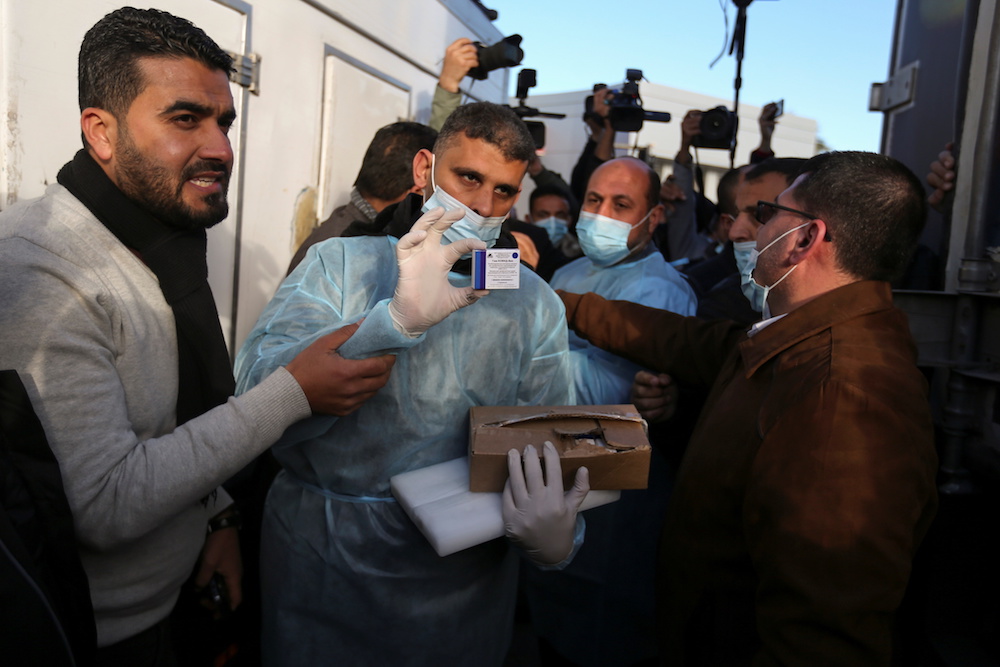 A Palestinian health worker shows a box of Russia’s Sputnik V vaccine sent by UAE, amid the coronavirus disease (COVID-19) outbreak, at Rafah crossing in the southern Gaza Strip Feb. 21, 2021. (Reuters)
