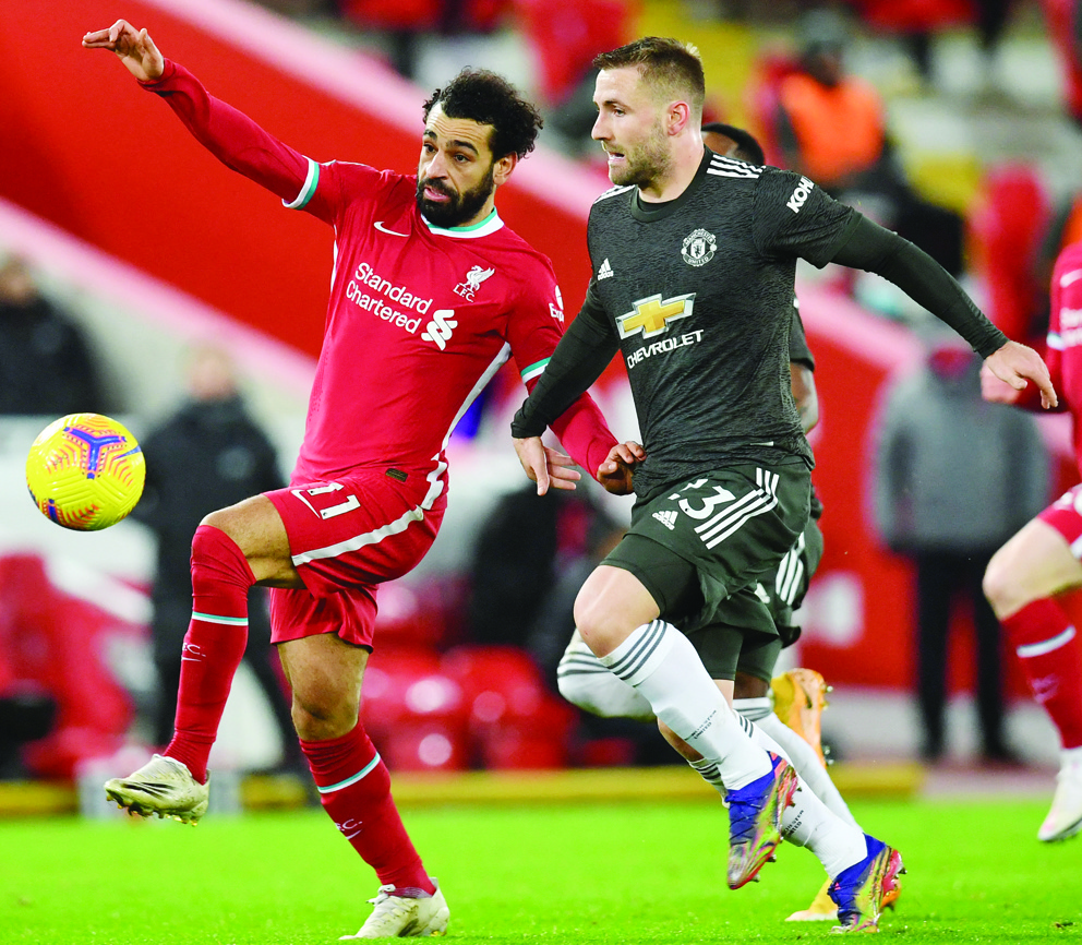 Liverpool’s midfielder Mohamed Salah vies with Manchester United’s defender Luke Shaw during a recent Premier League match at Anfield in northwest England. (AFP/File)