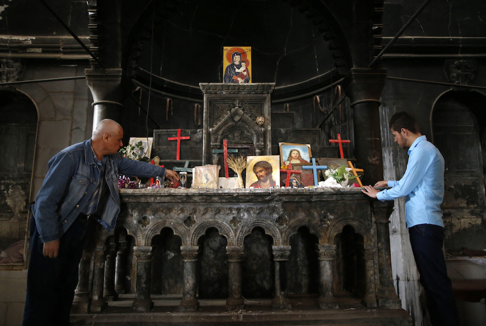Iraqi Christians of Qaraqosh attend the first Palm Sunday service at the heavily damaged Church of the Immaculate Conception on April 9, 2017, since Iraqi forces recaptured it from Daesh. (AFP/File Photo) Iraqi Christians of Qaraqosh attend the first Palm Sunday service at the heavily damaged Church of the Immaculate Conception on April 9, 2017, since Iraqi forces recaptured it from Daesh. (AFP/File Photo)