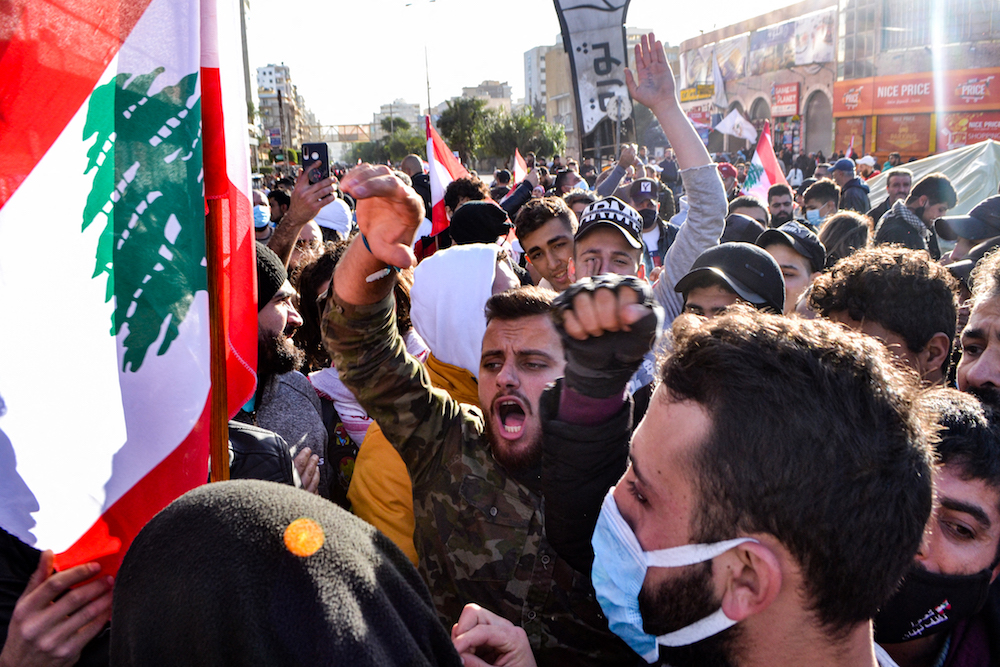 Anti-government protesters chant slogans during a demonstration in the centre of Lebanon's impoverished northern port city of Tripoli on January 31, 2021. (AFP)