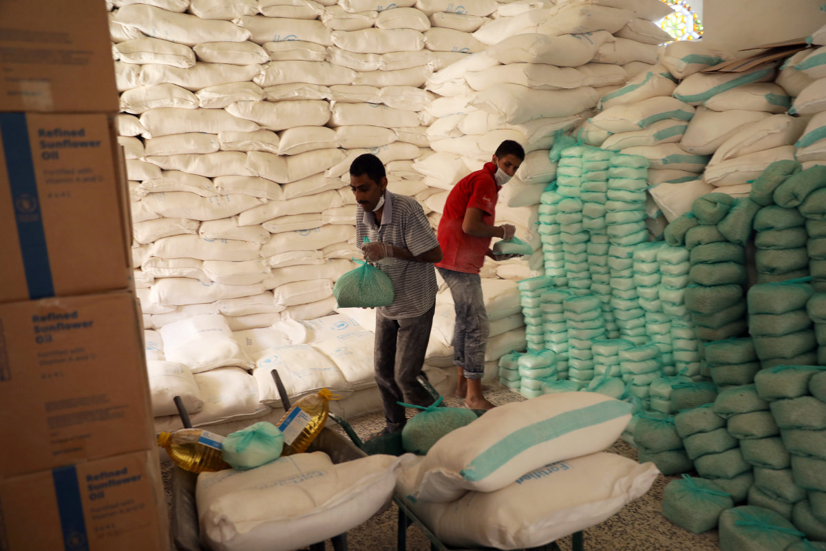 Workers prepare foodstuff for beneficiaries at a food distribution center supported by the World Food Program in Sanaa, Yemen, on June 3, 2020. (REUTERS/File Photo)