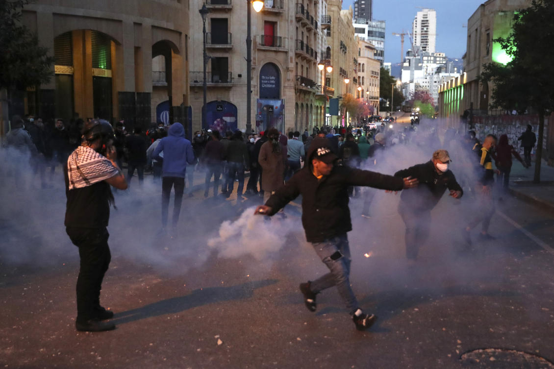Riot police fire tear gas against anti-government protesters, during a protest near Parliament Square, In Beirut, Lebanon, Saturday, March. 13, 2021. (AP)