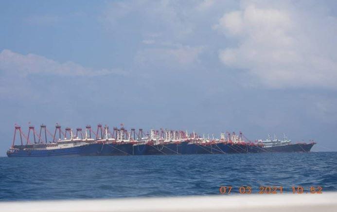 Chinese Maritime Militia vessels are massed at Julian Felipe Reef in the West Philippine Sea in this photo posted on Facebook by the Philippines' Presidential Communications office.