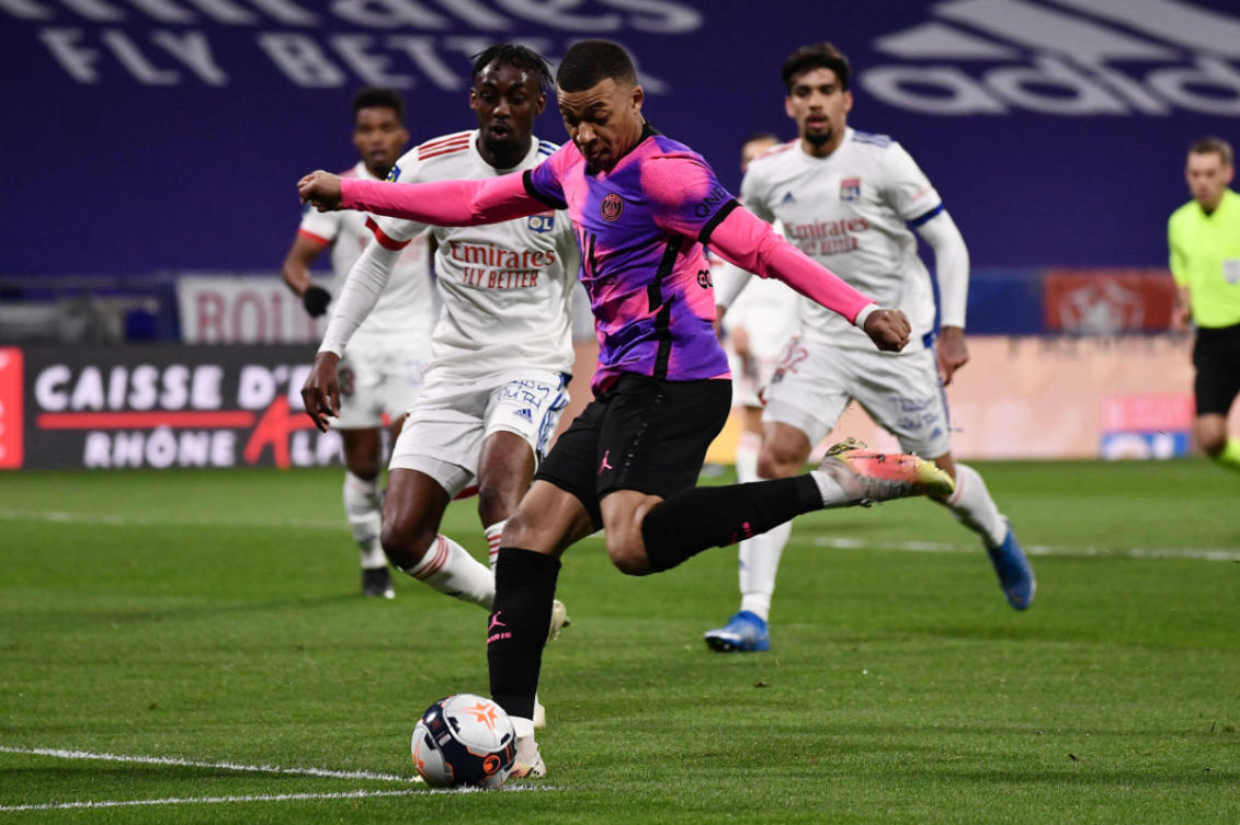 Paris Saint-Germain's French forward Kylian Mbappe shoots and scores a goal against Lyon (OL) at the Groupama Stadium in Decines-Charpieu, near Lyon, France, on March 21, 2021. (AFP / JEFF PACHOUD)