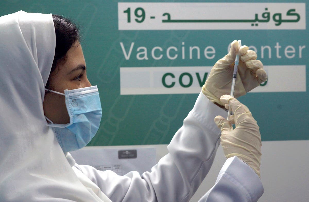 Saudi physician Hala Al-Kattan prepares to inject a Pfizer vaccine at a new coronavirus vaccination center at Jeddah’s old airport, Saudi Arabia. (File/AP)
