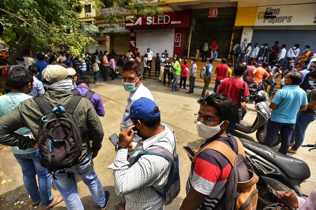 People queue outside the Chemists Association office for Remdesivir, an antiviral drug, in Pune on April 9, 2021 as India surged past 13 million coronavirus cases. (AFP)